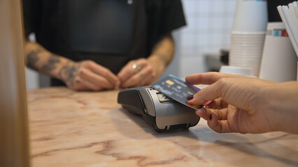 Woman buy take away coffee use nfc cashless payment close up. Contactless money transaction....