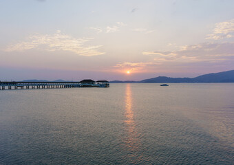 Sunset at the harbor to Immigration checkpoint and lighthouse for travel Myanmar by speed boat, Ranong , Thailand.