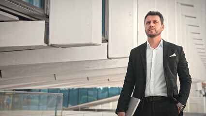 Handsome 30s top manager walking in formal suit. Successful entrepreneur stroll urban city street....