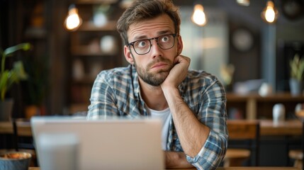 Obraz premium Tired young man feel pain eyestrain holding glasses rubbing dry irritated eyes fatigued from computer work, stressed man suffer from headache bad vision sight problem sit at home table using laptop