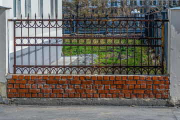 An empty front garden of an apartment building on a spring day