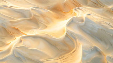 An abstract aerial view of a desert, with sand dunes creating wave-like patterns in shades of beige and cream, highlighted by the setting sun.