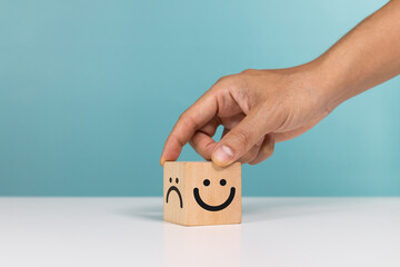 Service rating, satisfaction and positive feedback concept. Hand flip wooden cube change smile face...