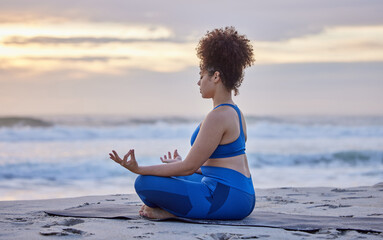 Yoga, lotus meditation and woman at beach at sunset for spiritual exercise, fitness or healthy body in summer. Padmasana, sea and girl in nature for zen, peace and calm mindfulness outdoor to relax
