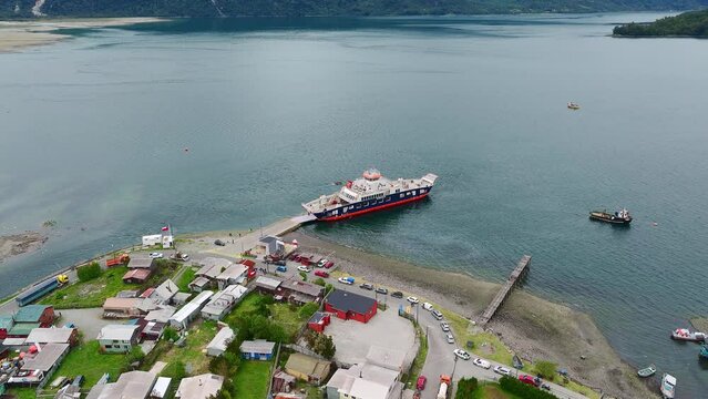 Aerial View Of Ferry Boat Docked At Ramp In Hornopiren Town Located In Commune Of Hualaihué in Palena Province, Southern Chile. Parallax Shot