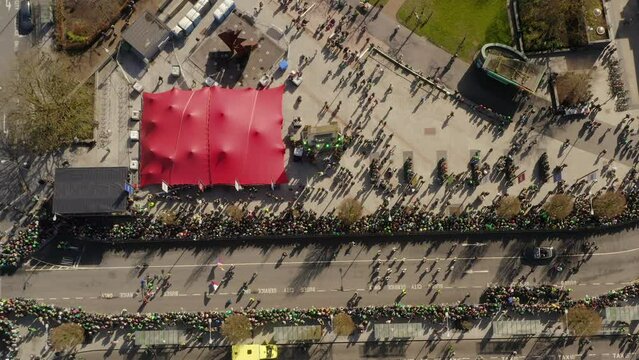 Eire square at St. Patrick's Day parade with crowds. Aerial topdown. Galway