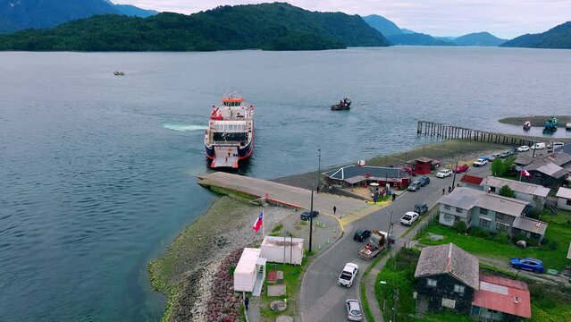 Ferry Boat Moored At Hornopiren Town Located In Commune Of Hualaihué in Palena Province, Southern Chile. Aerial Push Forward, Tilt Down Shot