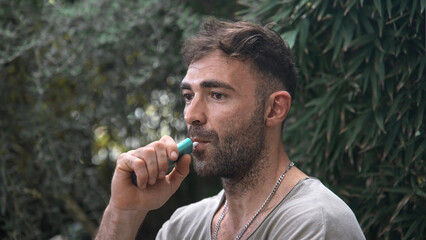 Heavy smoker use e cigarette close up. 40s man enjoy smoke electronic iqos stick. Male person abuse...