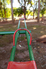 green and red metal seesaw