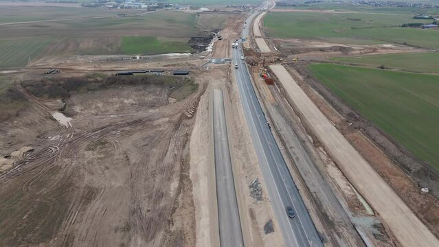 Drone shot of the road under construction for the expansion project, there is a construction site with the equipment for work.