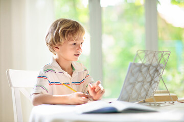 Online remote learning. School kid doing homework. - 793605097