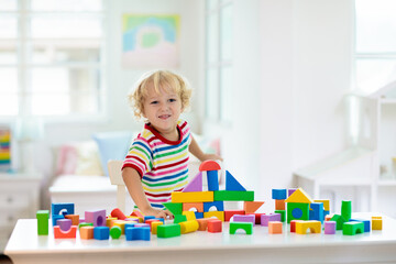 Kids toys. Child building tower of toy blocks. - 793605099