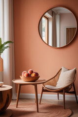 Interior with a wicker chair, a mirror on the wall and peaches in a bowl standing on the table. Peach-colored wall background. Shadow casting.