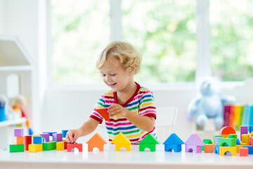 Kids toys. Child building tower of toy blocks. - 793606046
