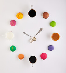 An insect themed clock ornament with colorful circles on a white background