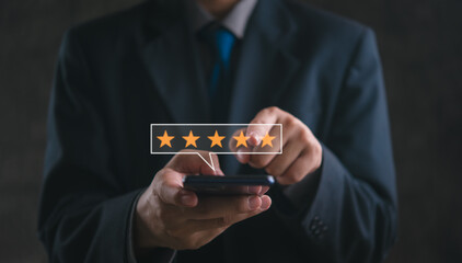 Businessman using mobile phone review rating feedback 5 star satisfaction marketing technology digital online customer service - 793610681