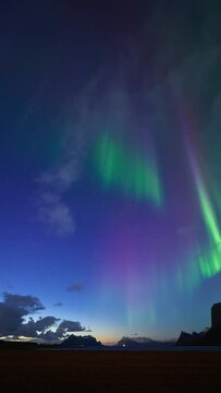 A twilight aurora captured in April displaying vibrant beautiful pillars above the fjords of northern Norway.