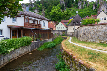 Fototapeta premium Small canal and houses in town Pottenstein, Franconian Switzerland, Germany