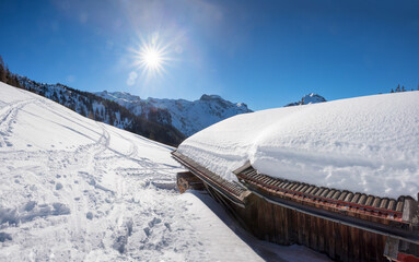 winter landscape with hut and bright sun, Zwolferkopf mountain pertisau - 793618624