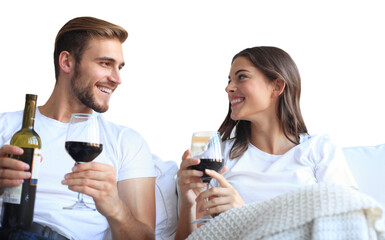 Young loving couple drinking a glass of red wine in their living room on a transparent background