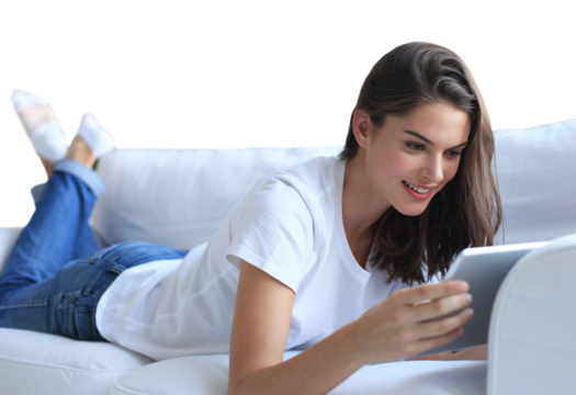 Beautiful young woman using tablet sitting on sofa at home at living room on a transparent background - Powered by Adobe