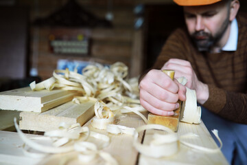Plane jointer carpenter or joiner tool and wood shavings. Woodworking tools on wooden table. Carpentry workshop