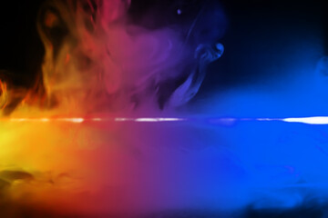 colorful smoke on dark background. Color steam on a black background. Red and blue smoke. Copy...