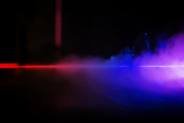 colorful smoke on dark background. Color steam on a black background. Red and blue smoke. Copy space.