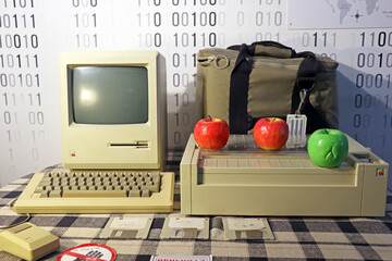An old retro computer stands on the table. Apple and engineer technology.