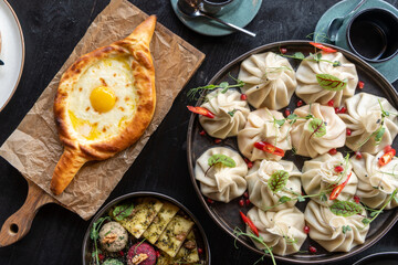 Golden-crusted Adjarian khachapuri teamed with succulent, spice-infused khinkali, assorted phali. A...