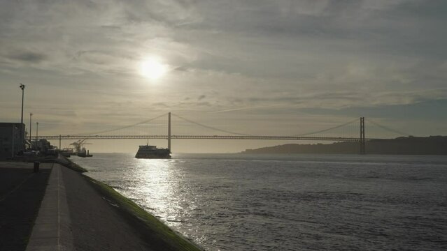 Lisbon, Portugal - Sunrise over 25 April Bridge of the Tagus River