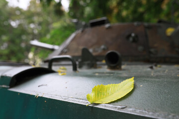 A selective focus shot of an abandoned military tank in the forest