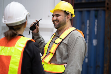 Happy Middle east logistic worker working with caucasian logistic engineer  woman at container site	