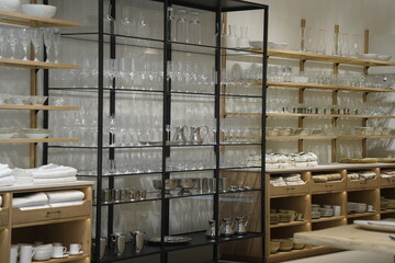 Glasses and dishes are displayed on the shelf