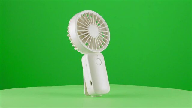 Handy fan electric hand mobile ventilator handyfan portable heat hot in a turntable with green screen for background removal 3d
