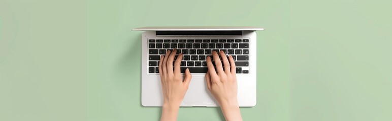 Overhead View of a Man's Hands Typing on a White Laptop