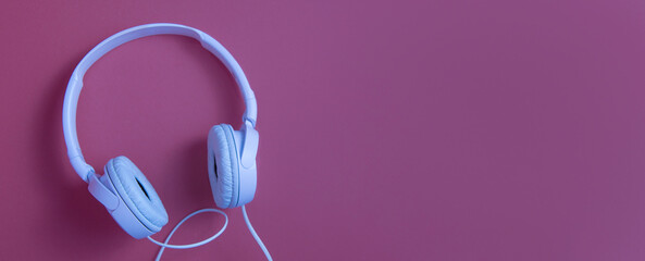 White headphones on a cherry background. copy space banner