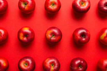 Many red apples on colored background, top view. Autumn pattern with fresh apple above view - Powered by Adobe
