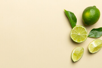 Lime fruits with green leaf and cut in half slice isolated on white background. Top view. Flat lay...