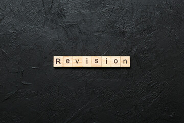 revision word written on wood block. revision text on table, concept