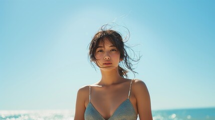 Portrait of young Asian women in bikinis on sea and sky background.