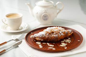 Almond Croissant on clay plate close up