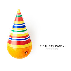 Colorful party birthday hat and orange fruit isolated on white background