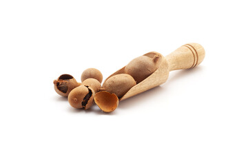 Front view of a wooden scoop filled with Fresh Organic Sweet Tamarind (Tamarindus indica) Frruit. Isolated on a white background. - obrazy, fototapety, plakaty