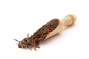 Top view of a wooden scoop filled with Organic sarpagandha (Rauvolfia serpentina) roots. Isolated...