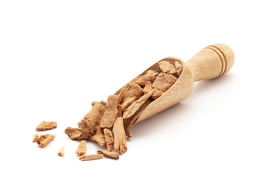Front view of a wooden scoop filled with Organic Lodhra Bark (Symplocos racemosa). Isolated on a white background.