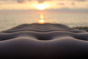 Inflatable mattress at the beach with blurry sea in background