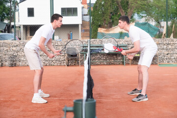 two people playing tennis