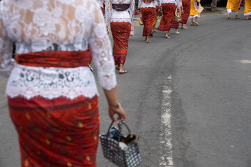 Balinese traditional wear while attending ceremonial event