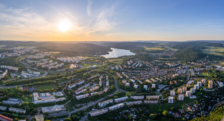 Panoramic aerial shot of Brno with dam and forests during sunrise